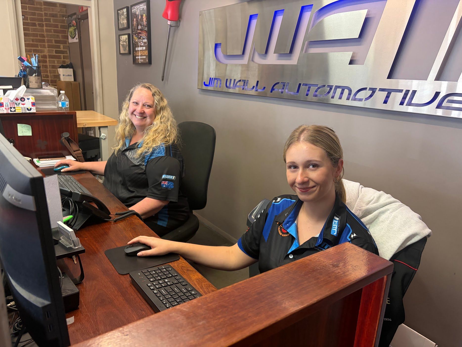 A Car is Sitting on a Lift in a Garage — Jim Wall Automotive in Mittagong, NSW