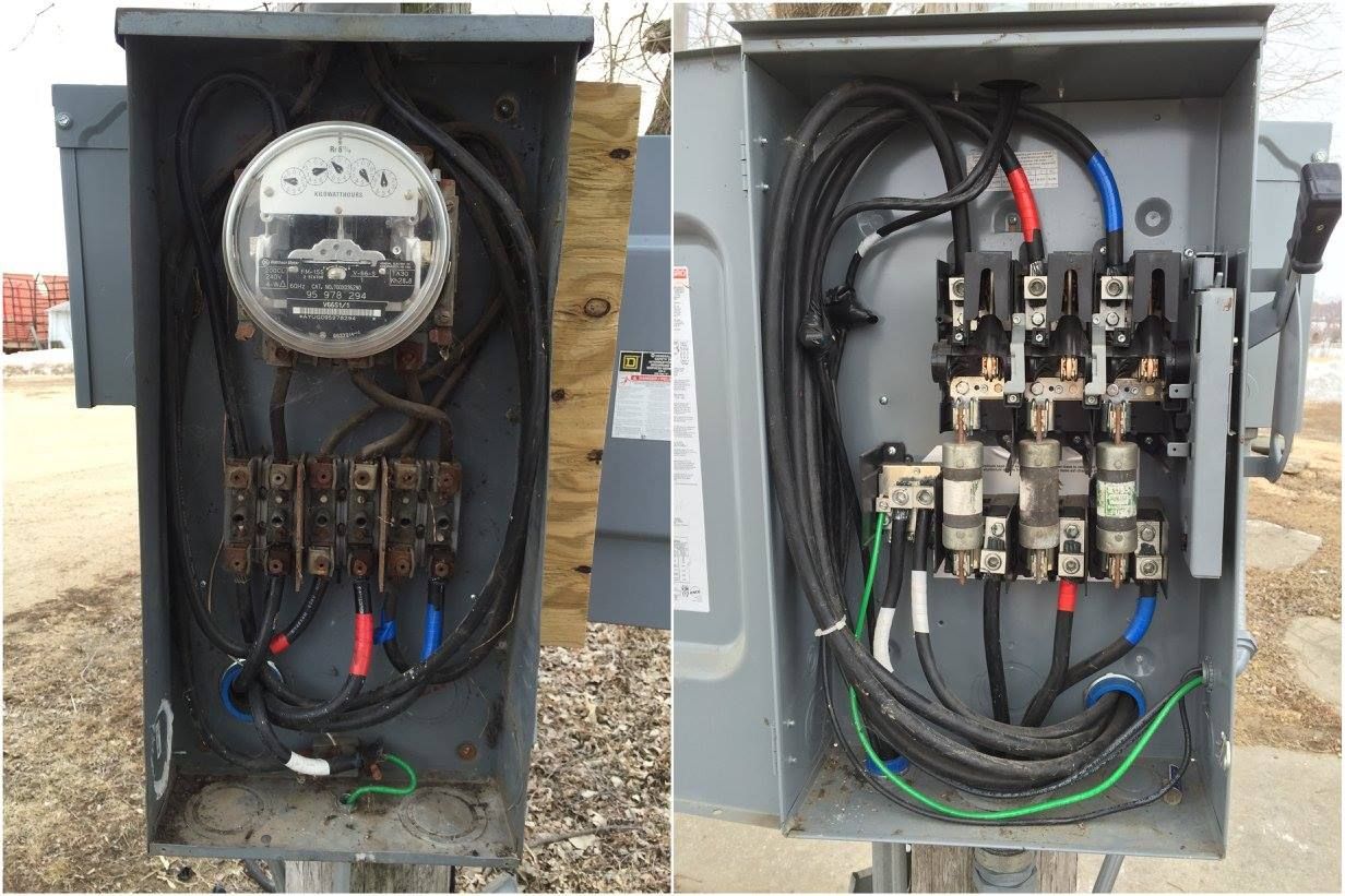 Open electrical meter and breaker panel boxes with exposed wiring and components.