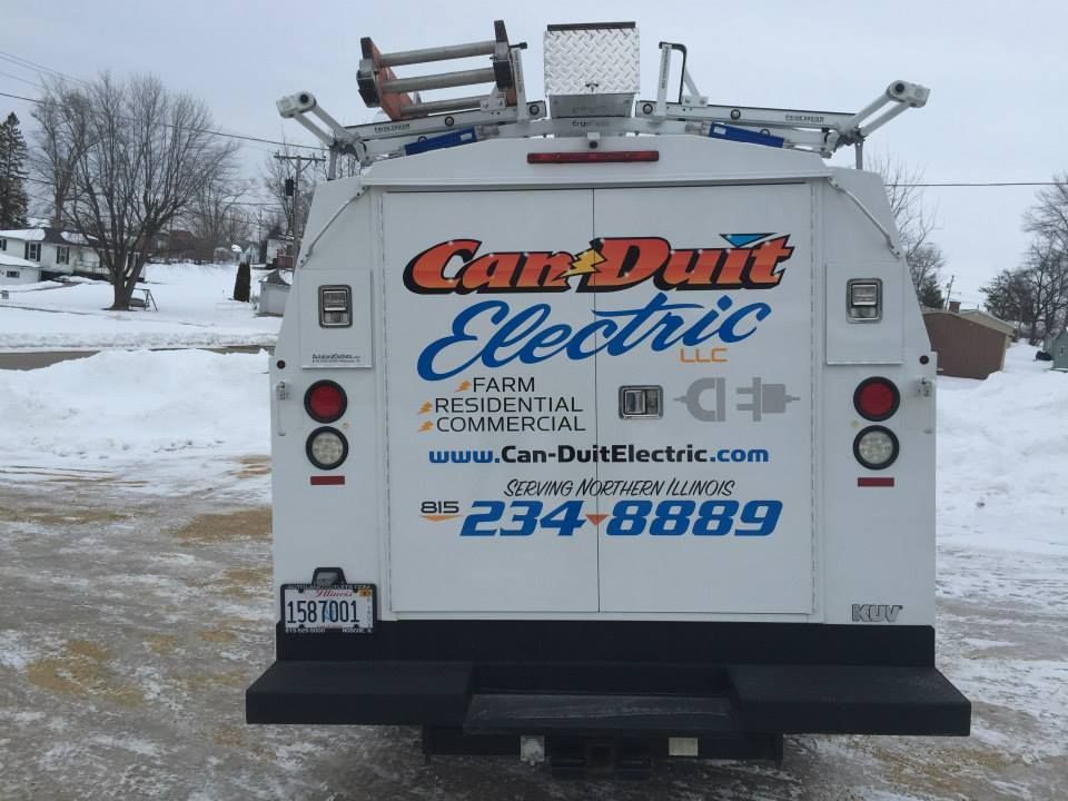 Rear view of a white Can-Duit Electric service van parked in a snowy lot with company logo and contact info.
