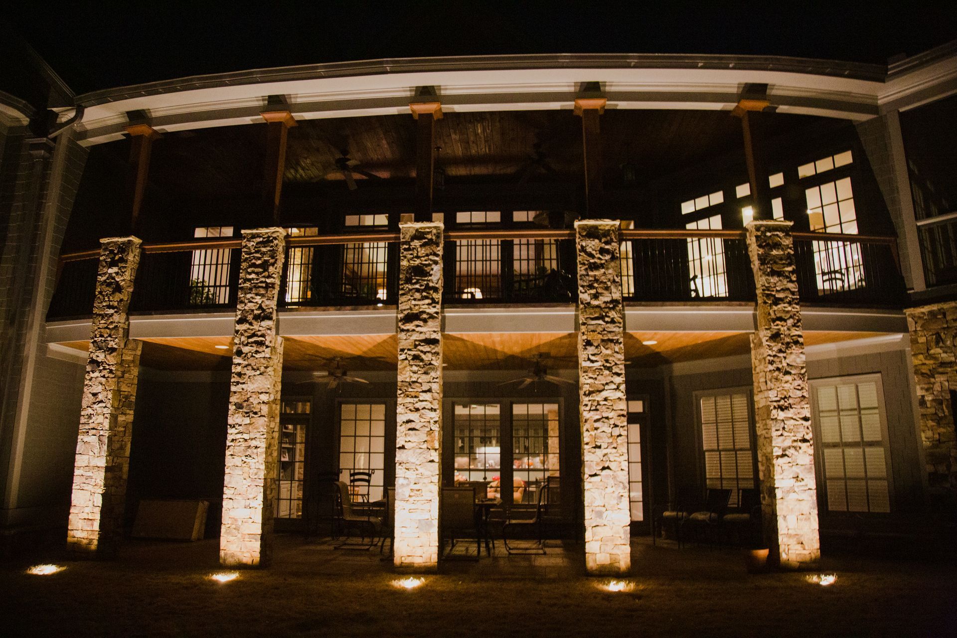 Night view of a lit building facade with stone columns and large windows