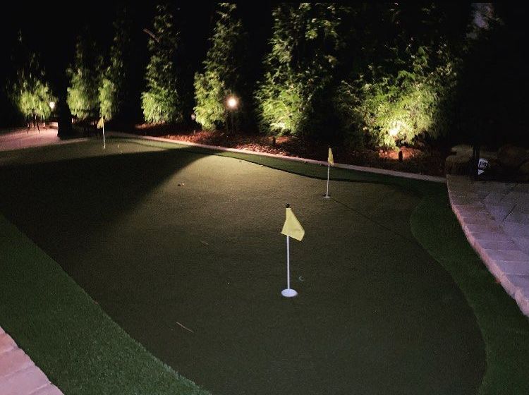 Lighted walkway leading following adjacent to home home