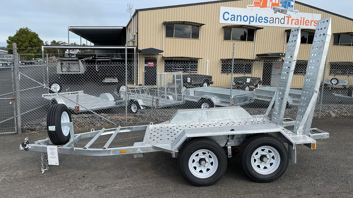Silver Trailer With Ramps And Two Wheels Parked Outside A Building — Towform Trailers in Bourke, NSW