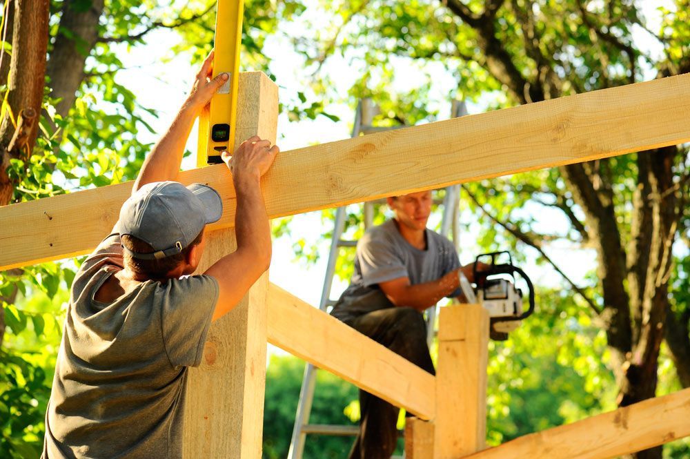 Two Men Are Working on a Wooden Structure — A. Webber Building in Callala Bay, NSW