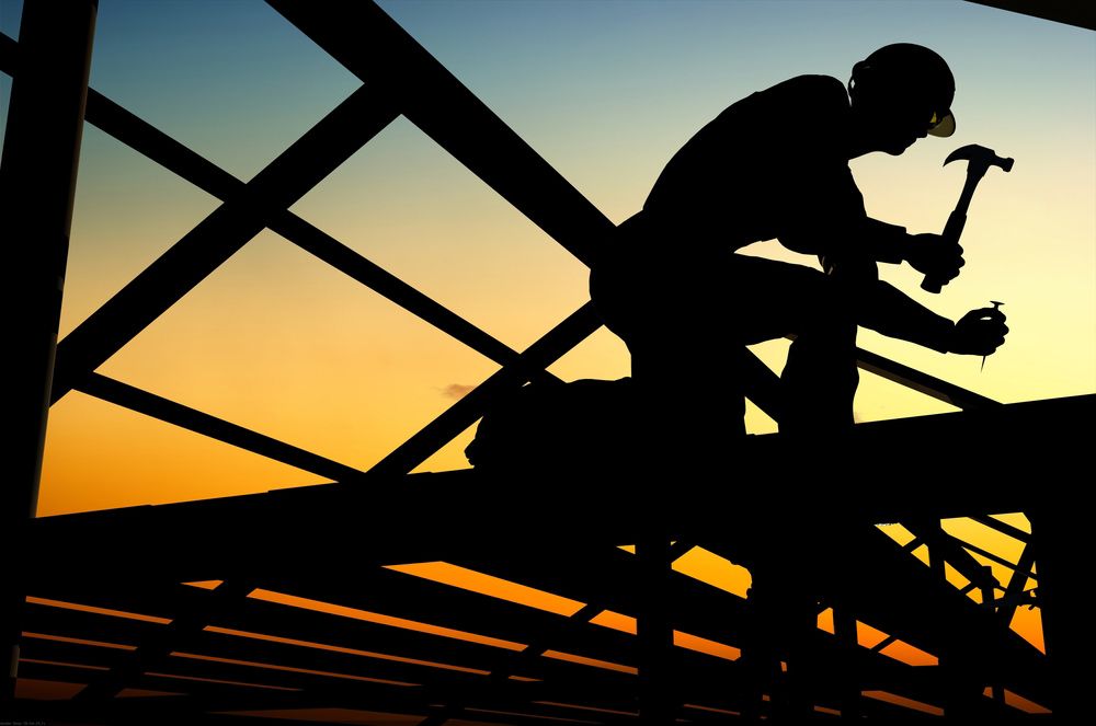 A Silhouette of a Man Working on a Bridge With a Hammer — A. Webber Building in Nowra, NSW