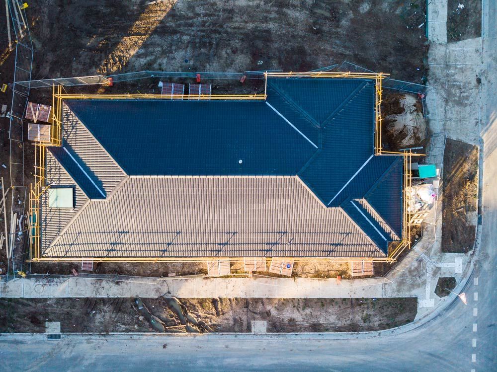 An Aerial View of a Building Under Construction With a Blue Roof — A. Webber Building in Jervis Bay, NSW