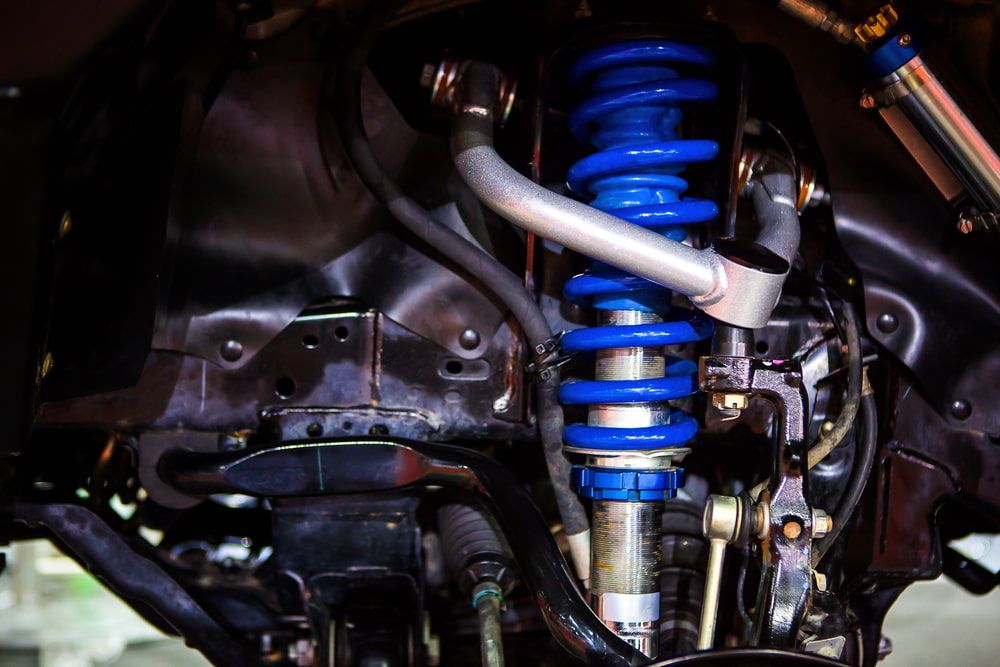 A Close Up of a Shock Absorber on a Car — Bowen Mechanical & Haulage in Bowen, QLD