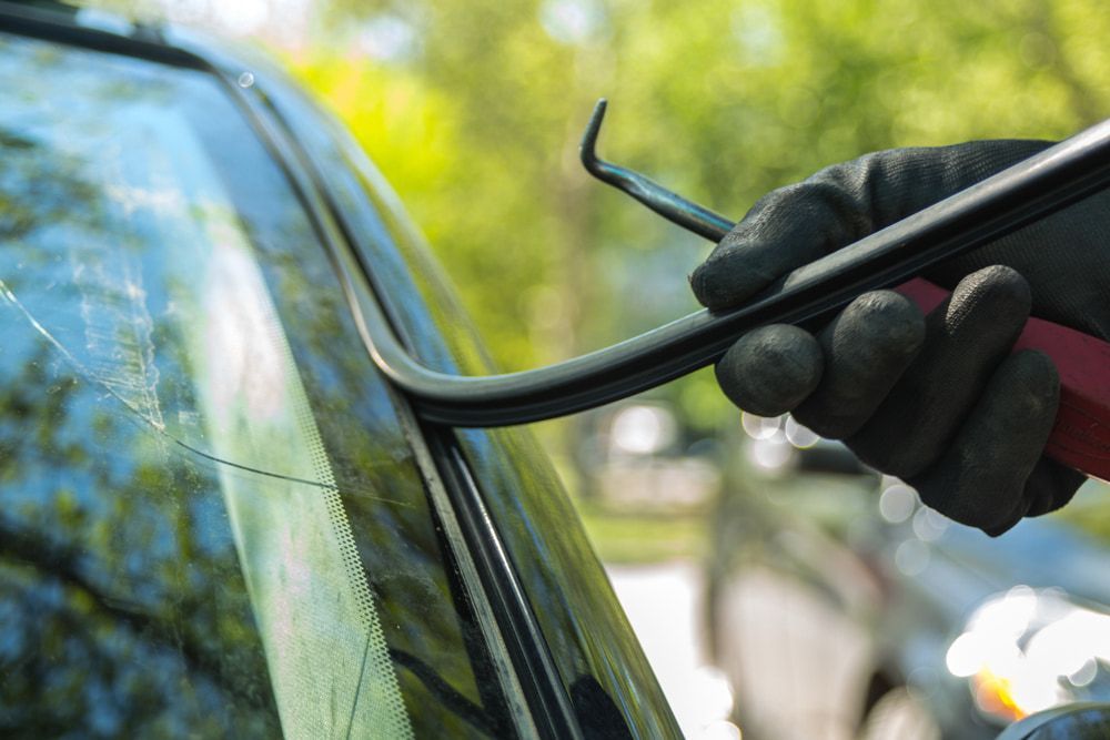 A Person is Fixing a Car Windshield With a Pair of Pliers — Bowen Mechanical & Haulage in Bowen, QLD