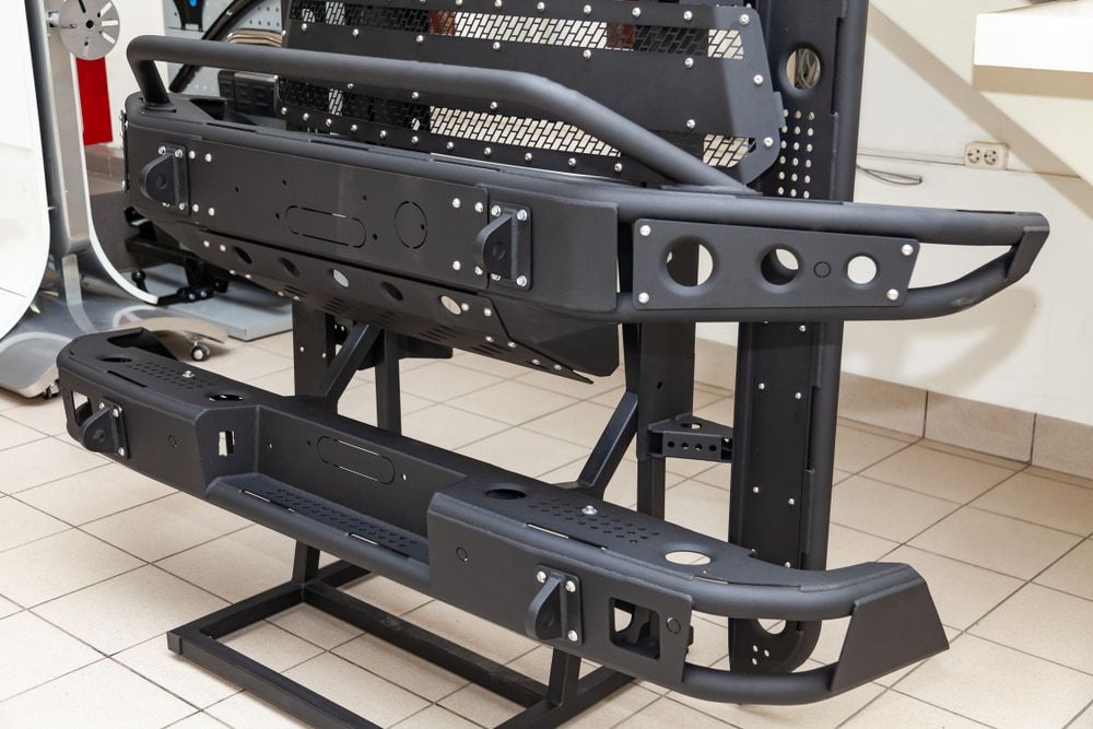 A Black Bumper is Sitting on Top of a Tiled Floor — Bowen Mechanical & Haulage in Bowen, QLD