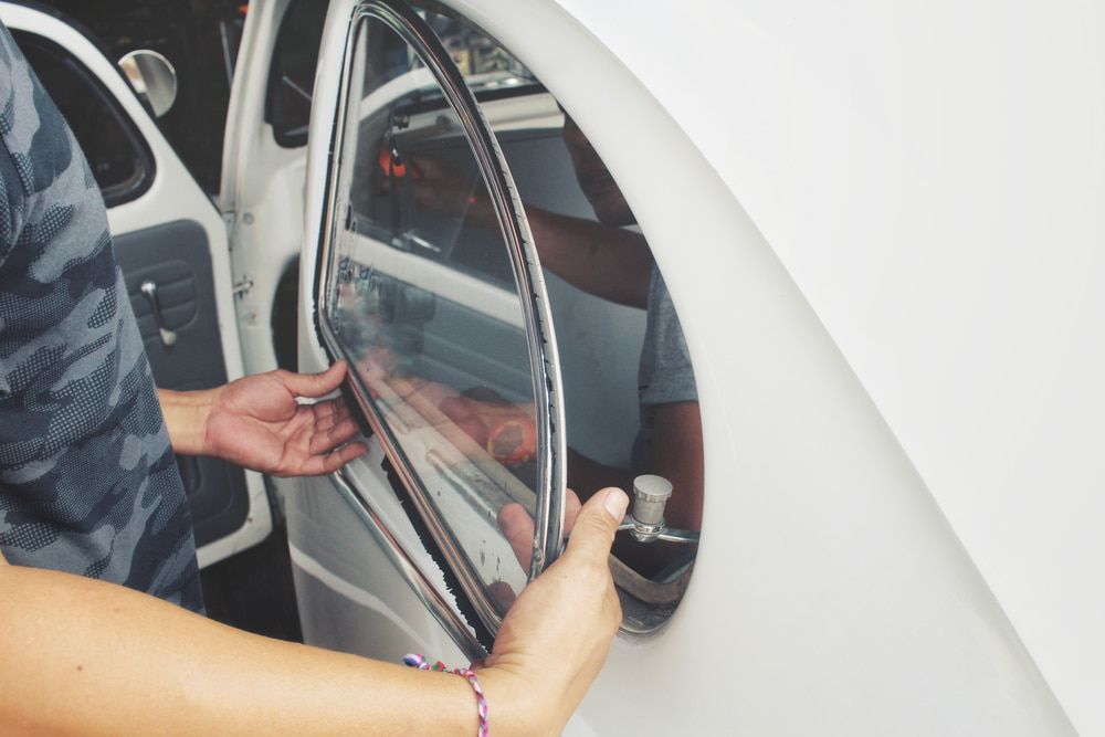 A Person is Opening the Door of a White Car — Bowen Mechanical & Haulage in Bowen, QLD