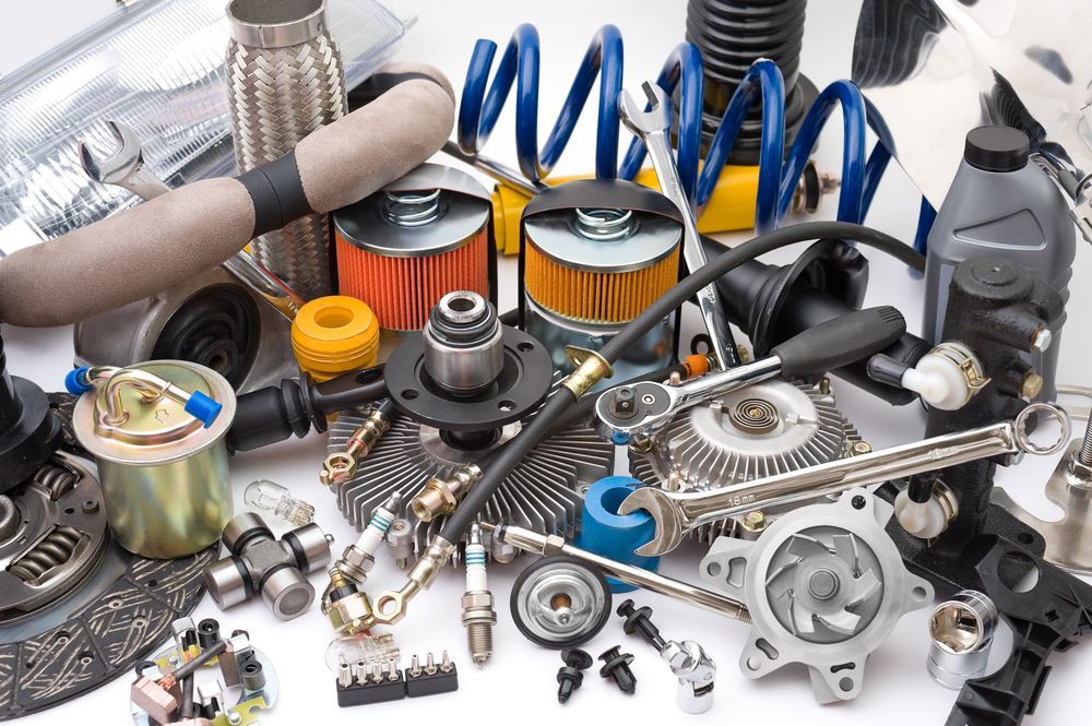 A Bunch of Car Parts on a White Surface — Bowen Mechanical & Haulage in Bowen, QLD