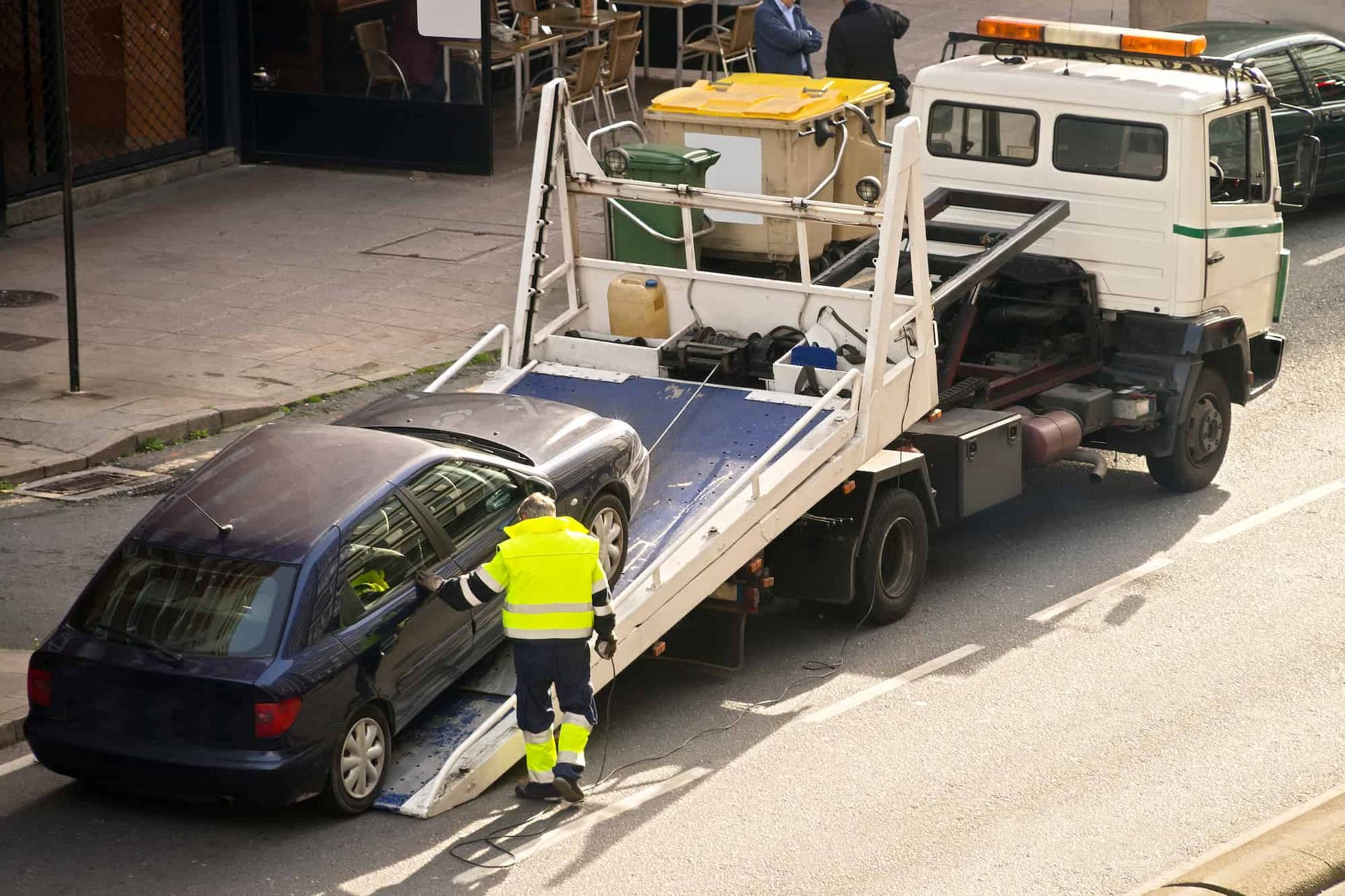 A Tow Truck is Towing a Car on the Side of the Road — Bowen Mechanical & Haulage in Bowen, QLD