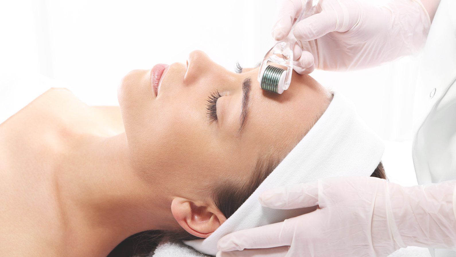 Woman getting microneedling treatment