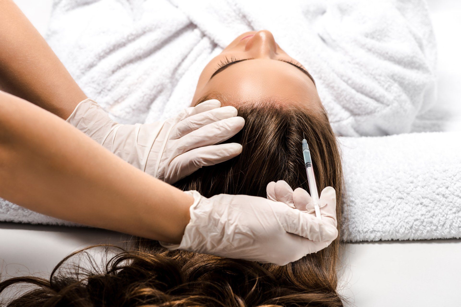 Woman receives injection for hair loss