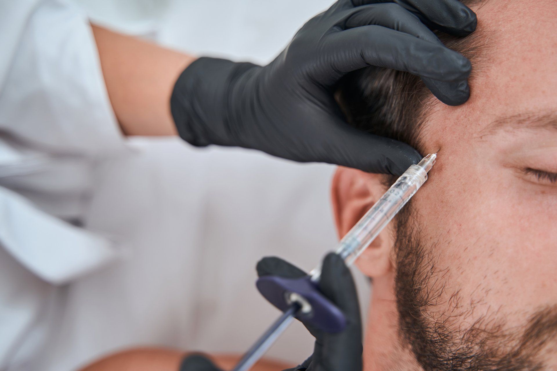 Male patient getting filler treatment
