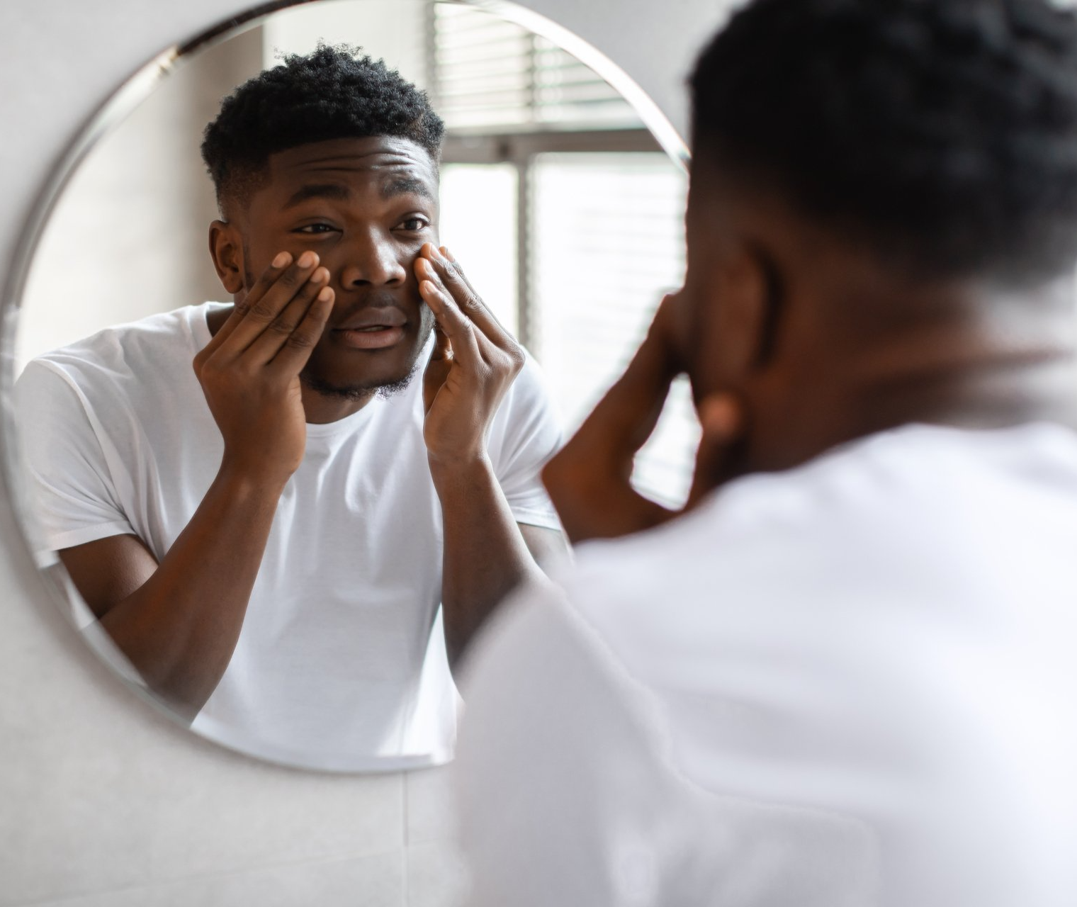 a sleepy black man with puffy undereyes