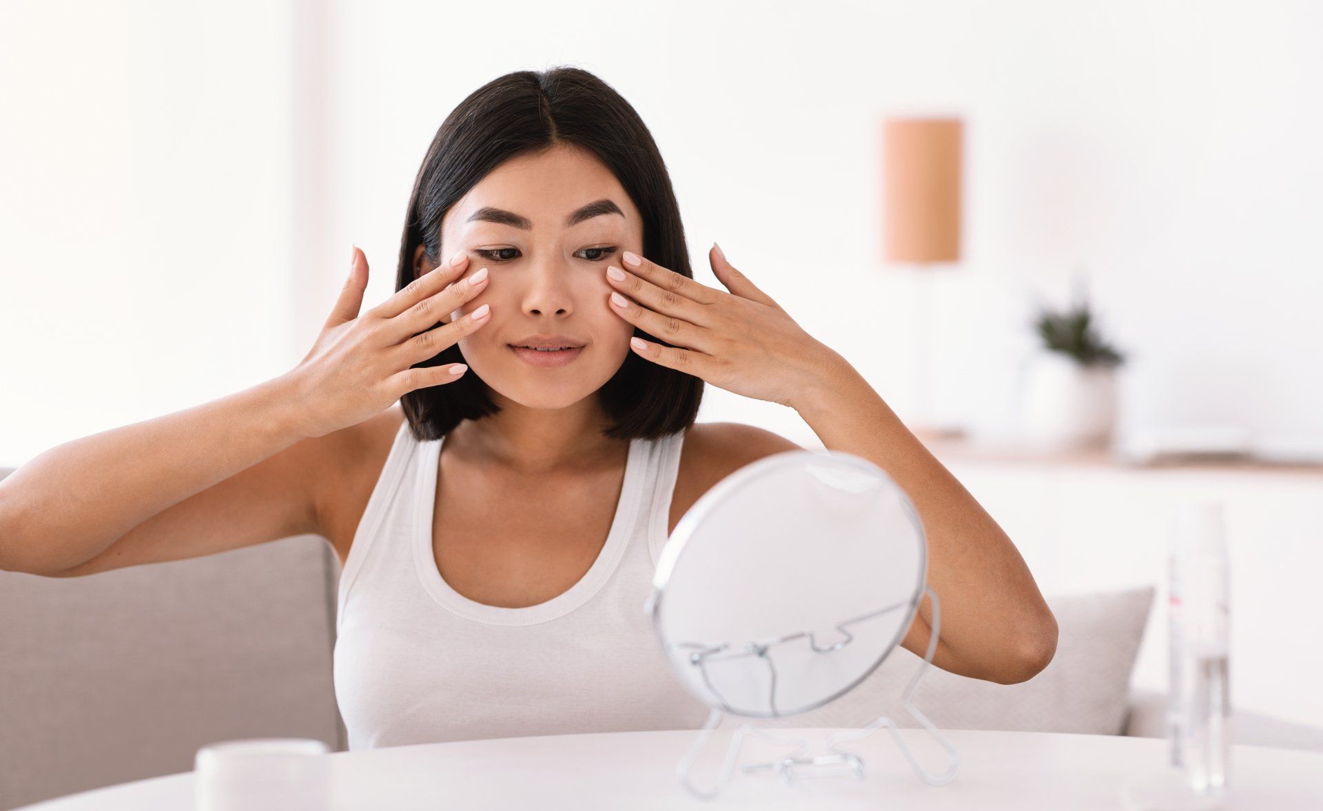 Woman looking at skin in mirror