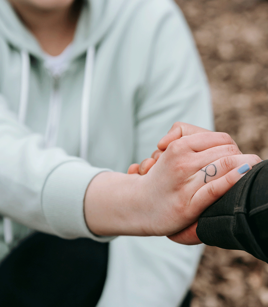 SAFE peer supporter holding the hand of a survivor
