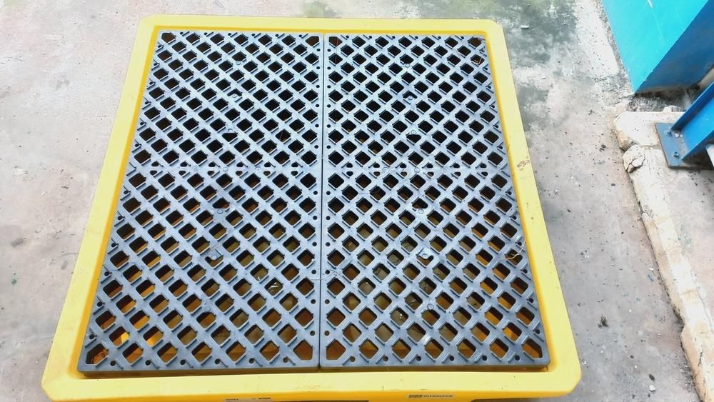 A Yellow and Black Plastic Tray With Holes in It is Sitting on the Ground — Envirokleen Solutions In Slade Point, QLD