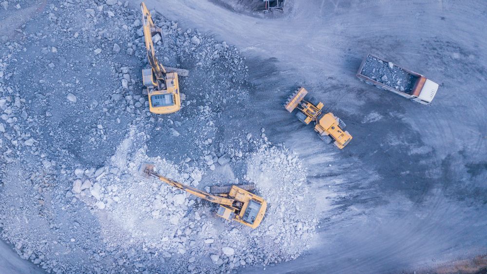 An Aerial View of A Construction Site with Trucks and Excavators — PBC Compliancing in Whitsundays, QLD