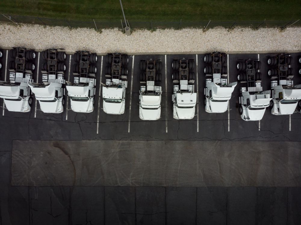 Aerial View of a Row of White Semi-truck — PBC Compliancing in Bowen Basin, QLD