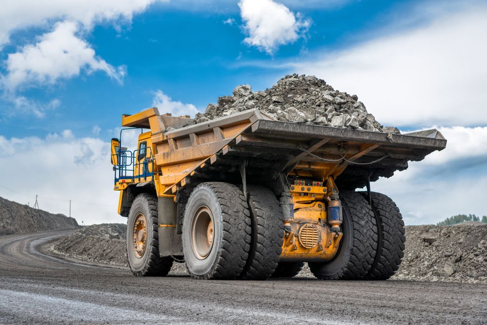 Mining Truck Loaded With Rocks Driving Along The Mountain —PBC Compliancing in Whitsundays, QLD