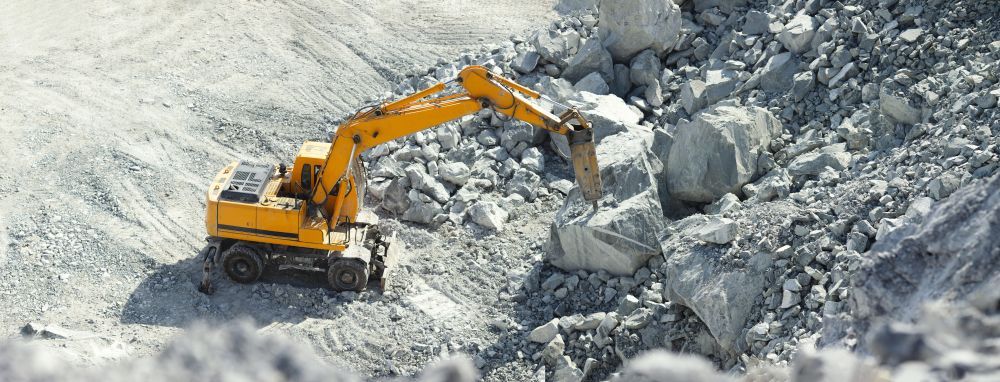 Hydraulic Hammer Works On A Huge Grey Stones — PBC Compliancing in Whitsundays, QLD