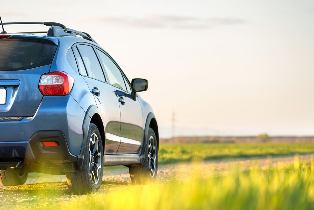 Blue Car On A Grassy Field — PBC Compliancing in Nebo, QLD