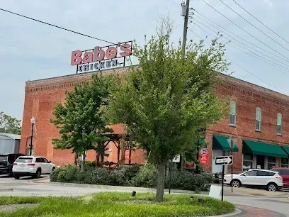 AT Electric LLC - This image showcases a charming brick restaurant with a vintage-style sign mounted on top, attracting customers with its classic appeal.