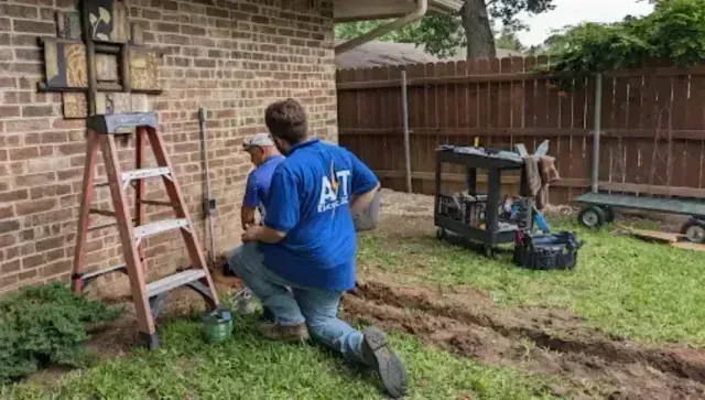 Local Electricians – Local electricians are shown working on an outdoor electrical installation project, demonstrating their expertise in handling residential wiring and exterior power needs.