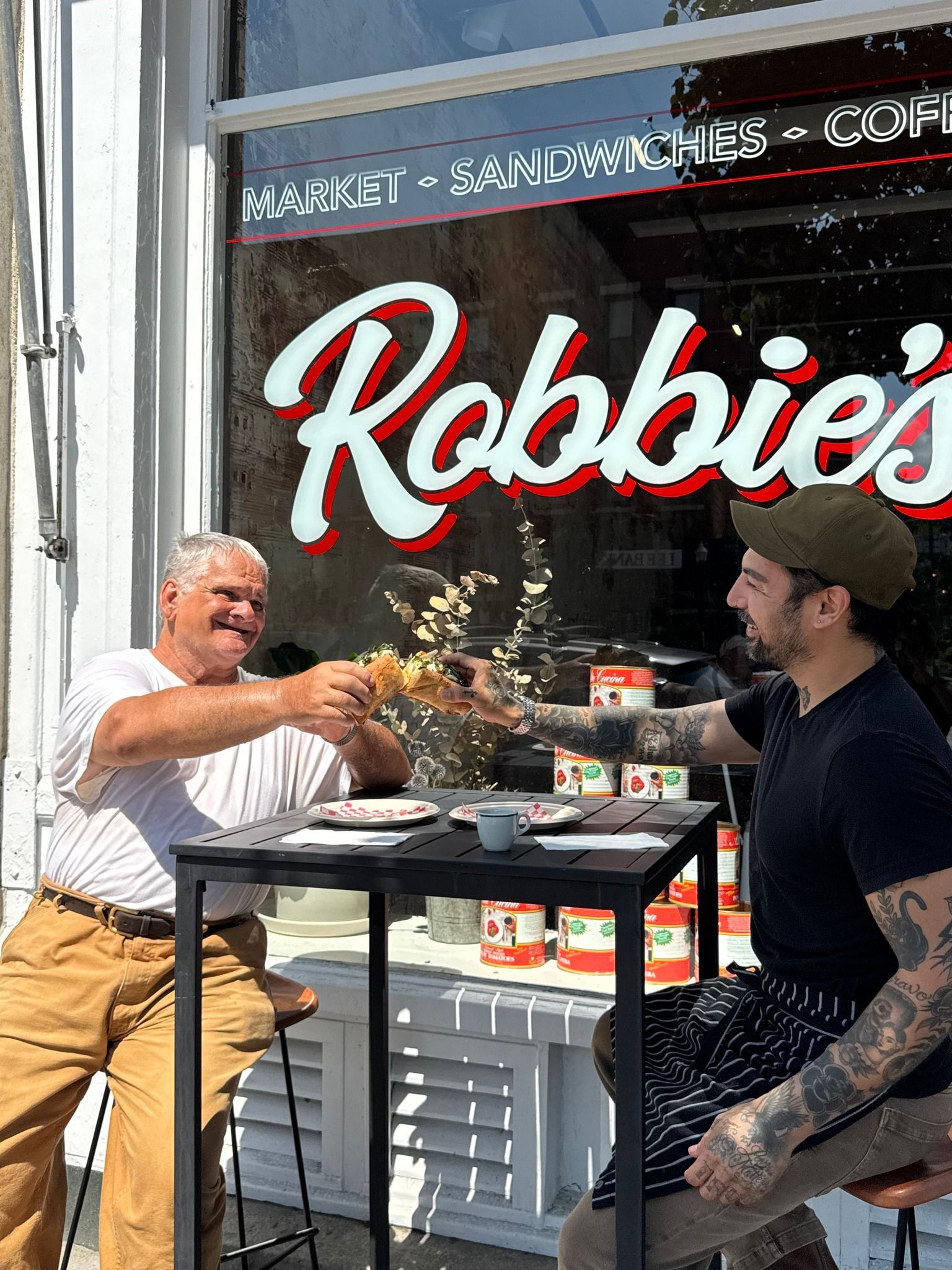 Two men toasting outside 