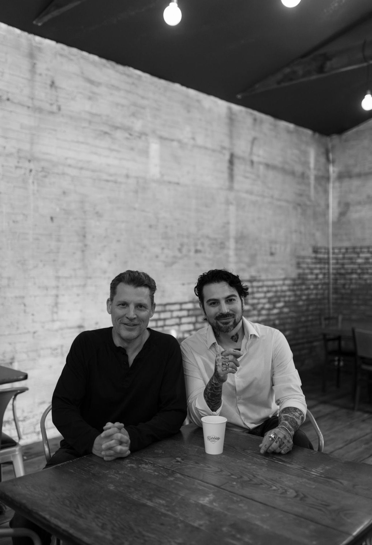 Two men toasting outside 