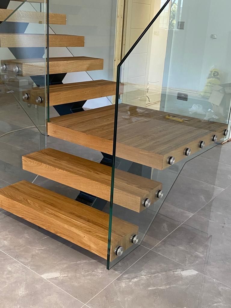 Custom metal staircase with timber treads and glass balustrade London