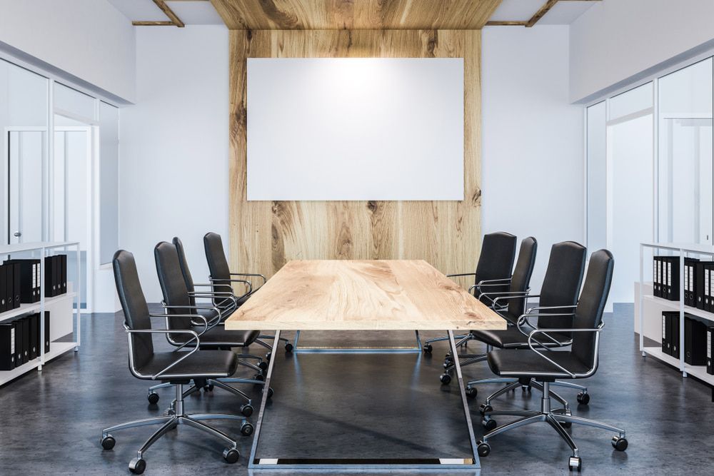 A Conference Room with A Long Wooden Table and Chairs — Solarmaster in Gold Coast, QLD