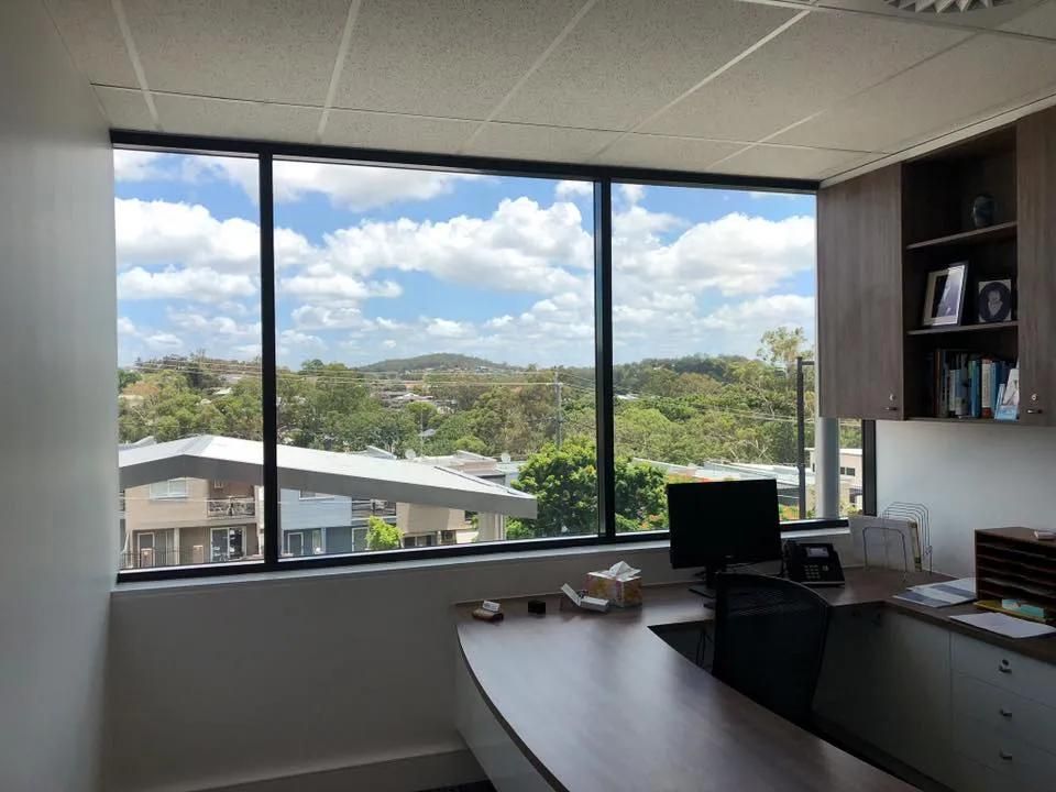 An Office with A Large Window and A Desk with A Computer on It — Solarmaster in Murarrie, QLD