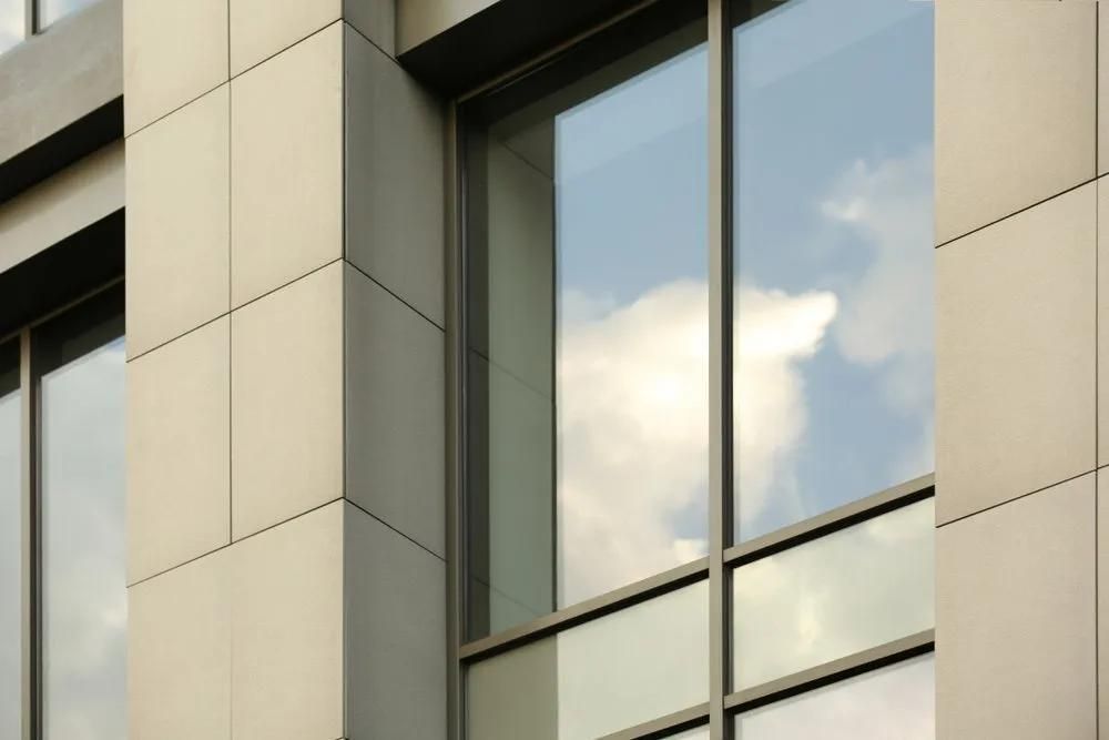 A Building with A Lot of Windows and A Reflection of Clouds in The Windows — Solarmaster in Tweed Heads, NSW
