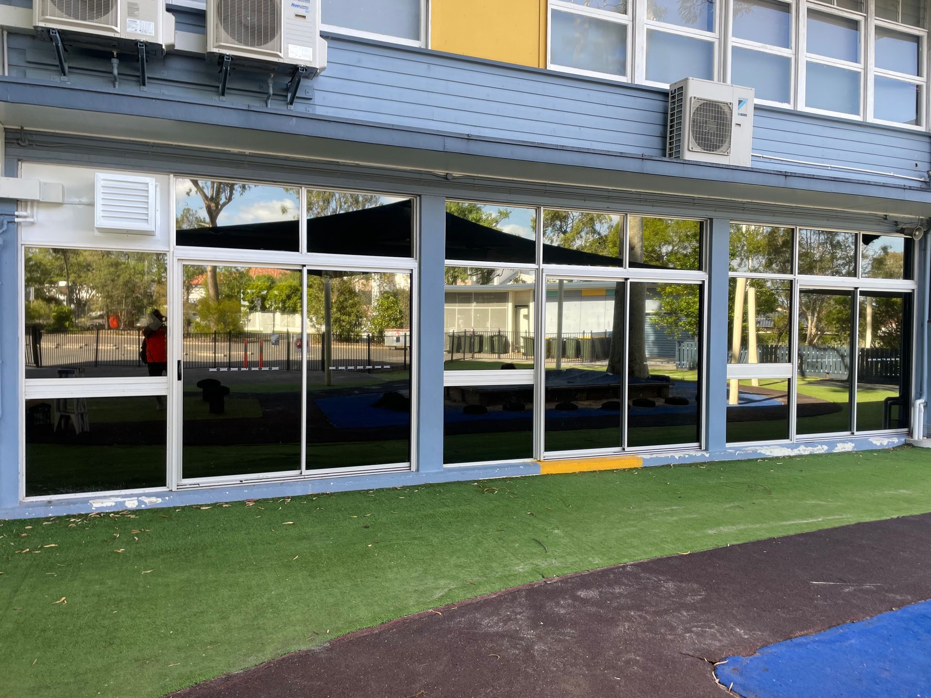 A Large Building With a Lot of Windows and Air Conditioners — Solarmaster in Gold Coast, QLD
