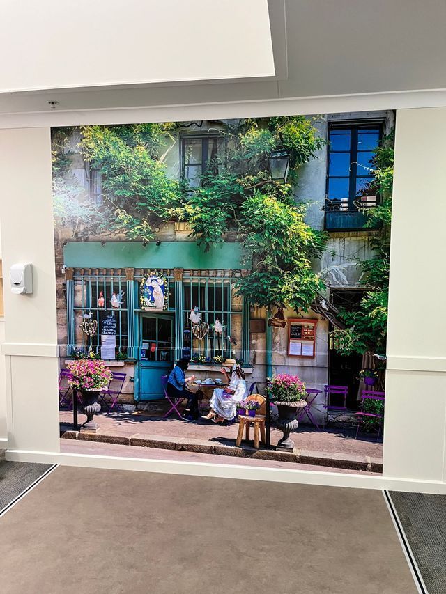 A Wall With a Picture of People Sitting at Tables in Front of a Building — Solarmaster in Gold Coast, QLD