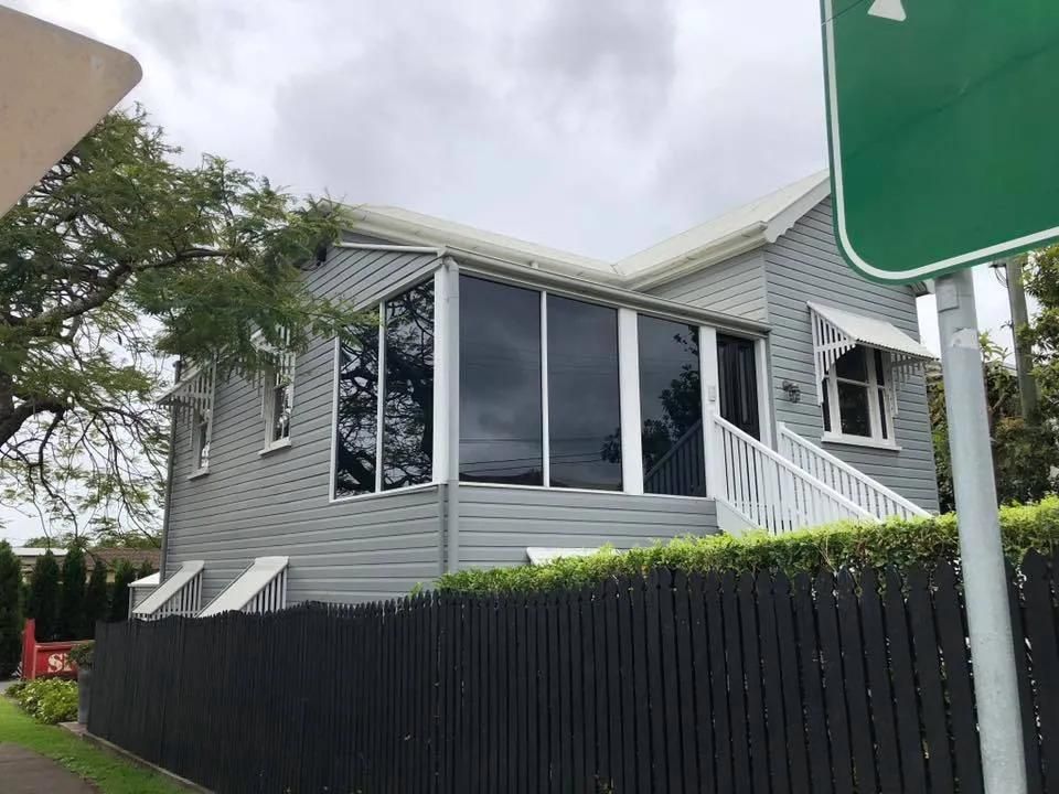 A House with A Green Sign in Front of It — Solarmaster in Brisbane, QLD