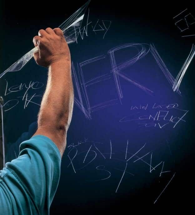 A Man in A Blue Shirt Is Writing on A Chalkboard — Solarmaster in Murarrie, QLD