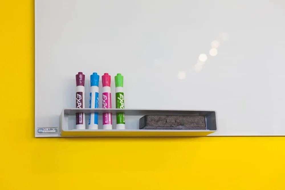 A Whiteboard with Markers and A Eraser on A Yellow Wall — Solarmaster in Gold Coast, QLD