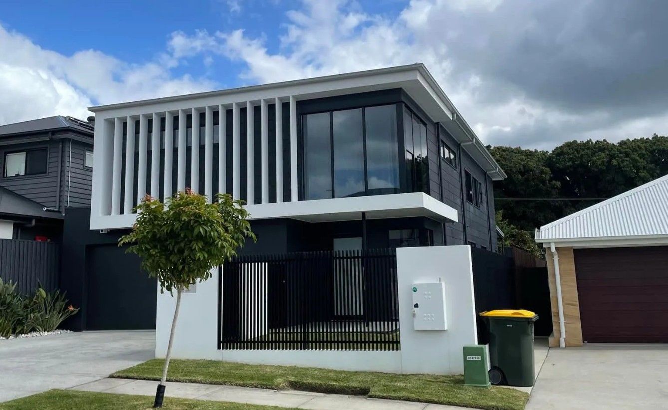 A Modern House with A Black Fence and A Large Window — Solarmaster in Murarrie, QLD