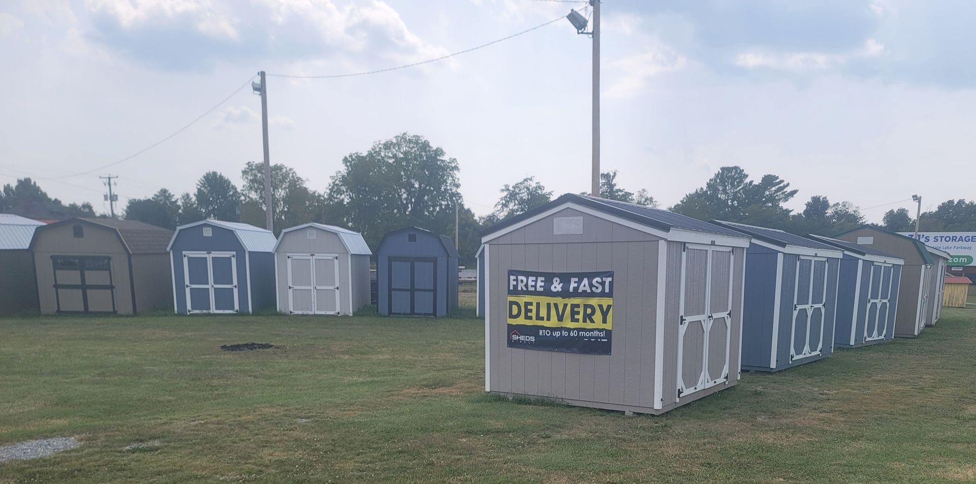 Line of storage sheds in a grassy field; the closest one has a 