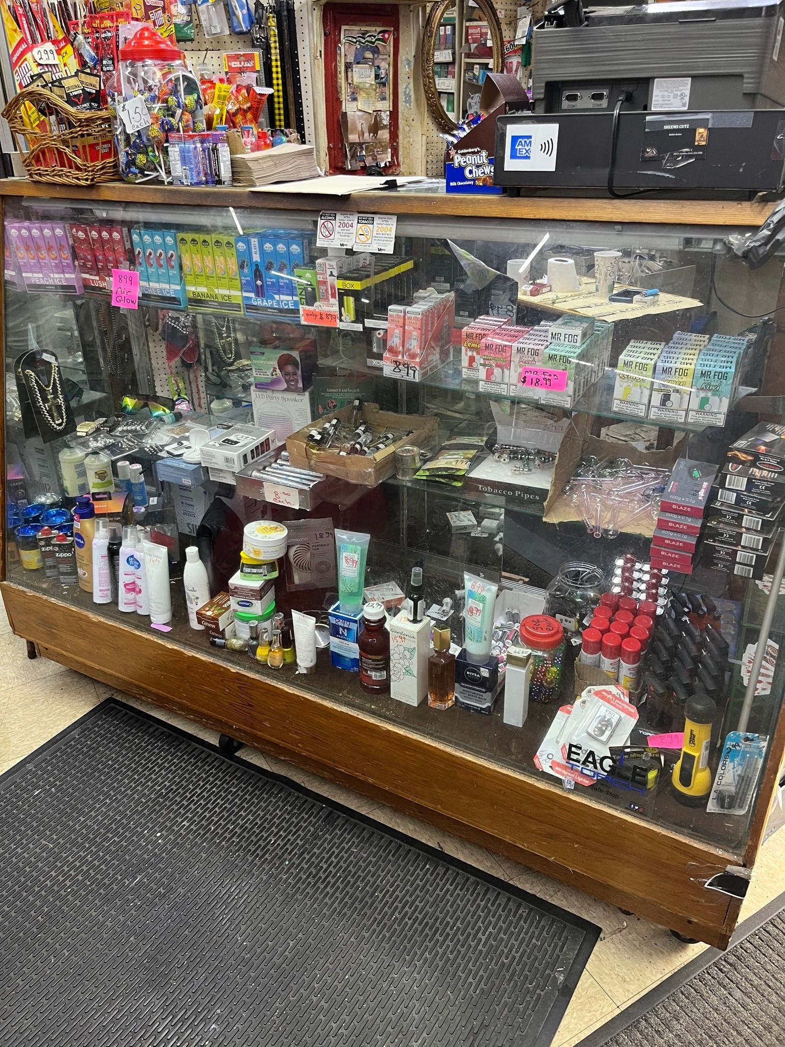 Glass display case filled with various items, possibly in a store setting.