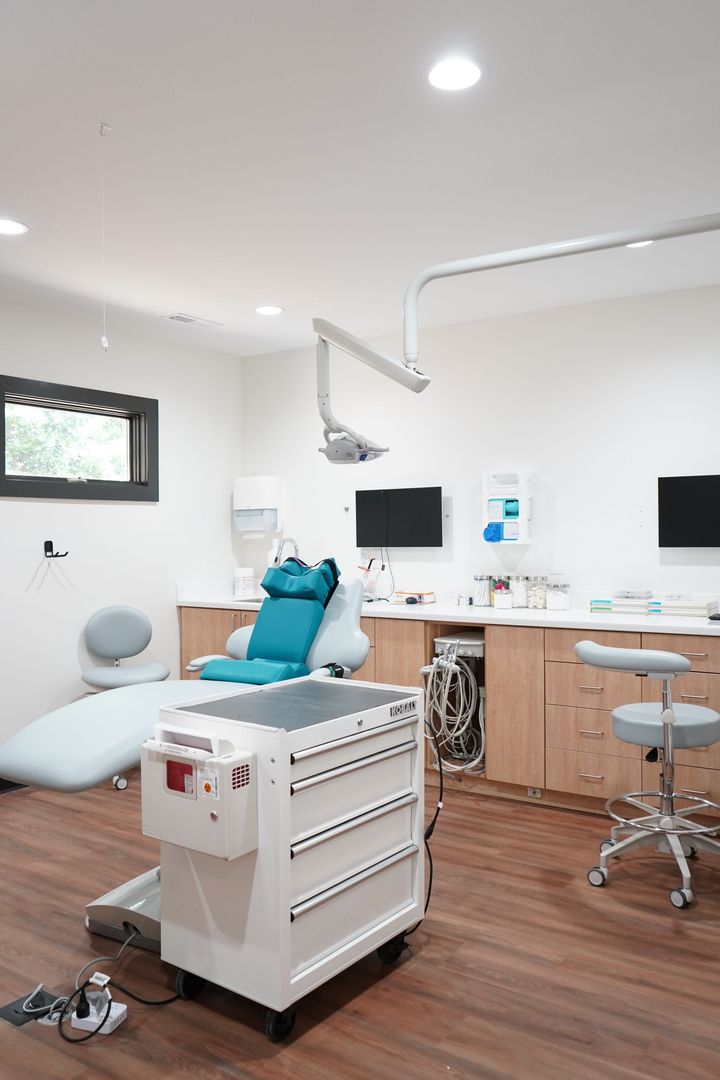 A dental office with a dental chair and dental equipment