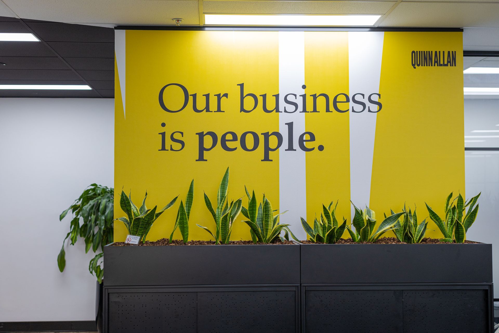 Yellow office wall sign reading 