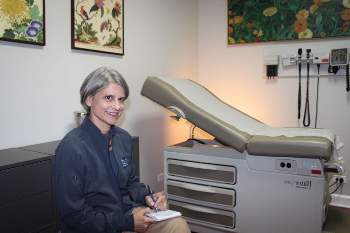 Dr. Amy sitting with Rx pad