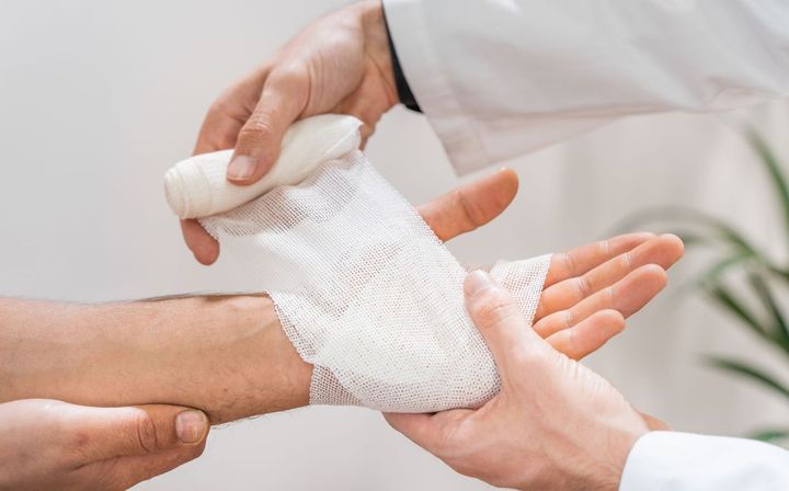 Doctor applying bandage