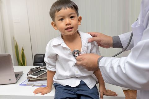 Pediatrician diagnosing boy