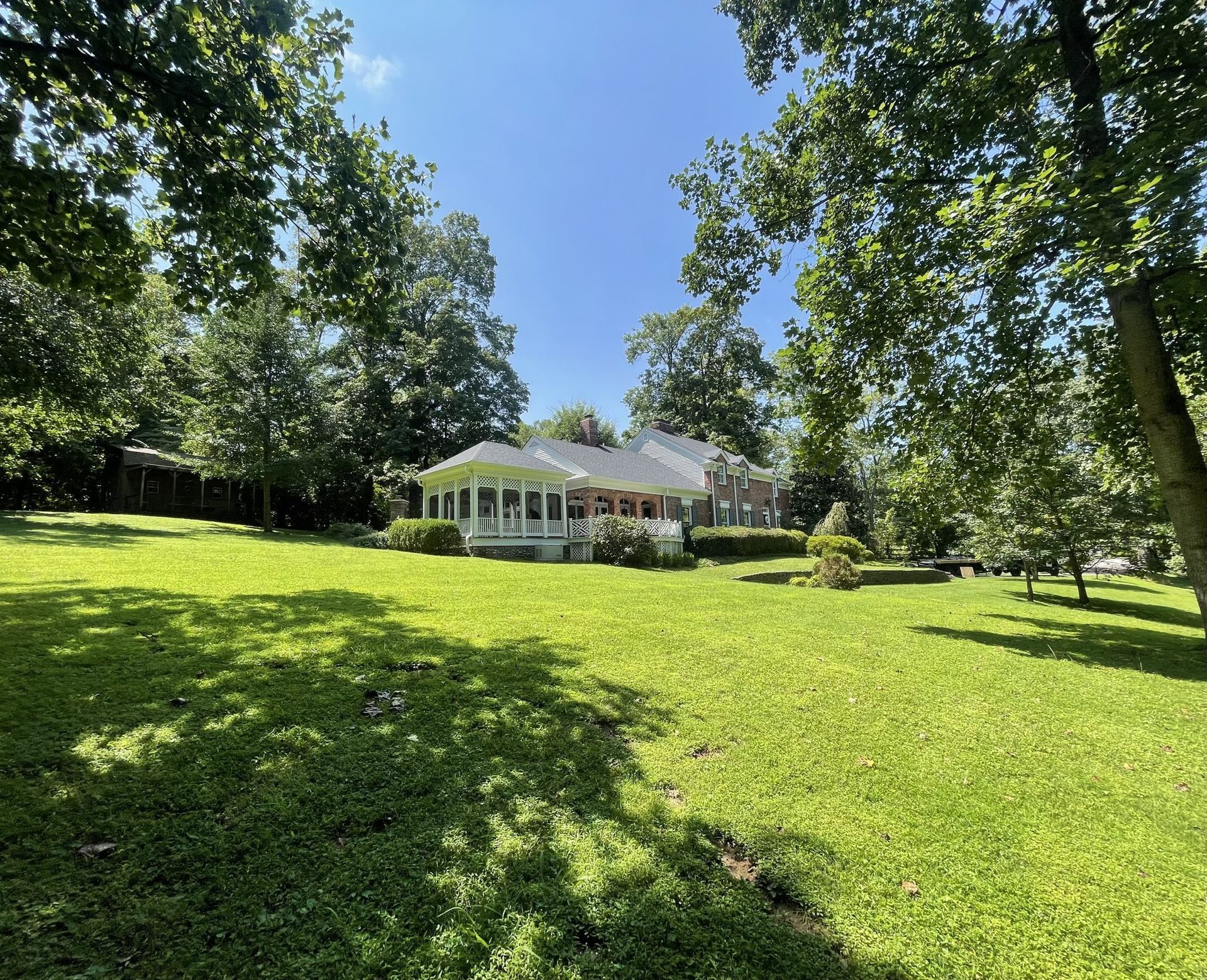 Brick home with a shingle roof by Falls City Contracting in Kentucky