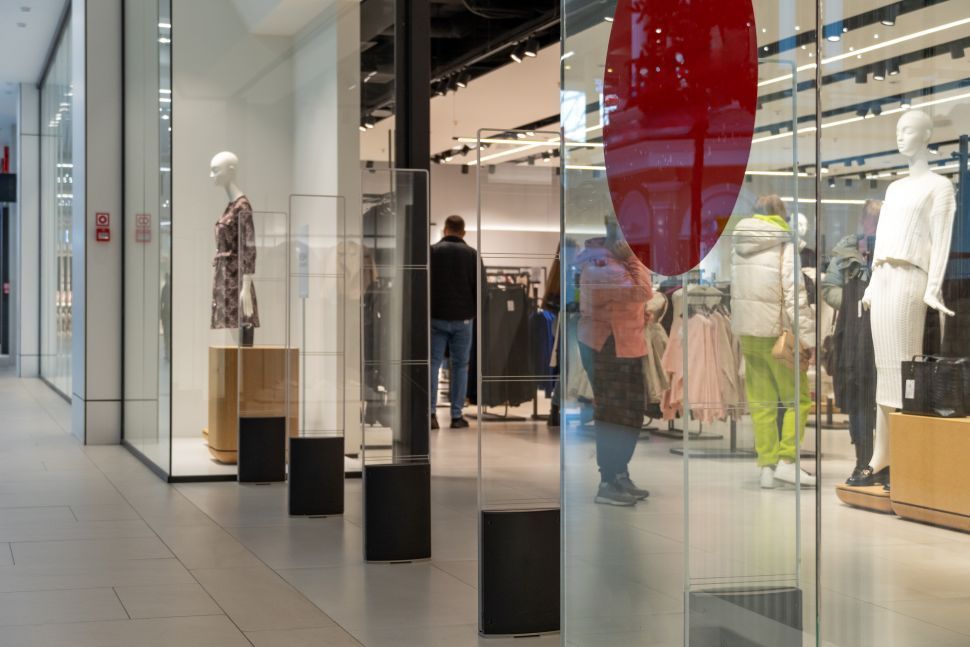 retail shop storefront in a mall with mannequins and entry security system